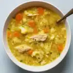 anti-inflammatory cauliflower chicken soup in rustic bowl