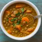 carrot and lentil soup in rustic bowl