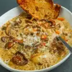 creamy mushroom chicken and wild rice soup in rustic bowl