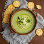 Italian Broccoli Soup topped with parmesan and olive oil in rustic bowl