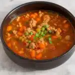 Italian Turkey Burger Soup in a rustic bowl with garnish.