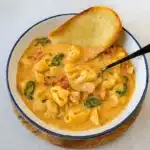 Creamy Marry Me Chicken Soup served in a Dutch oven with fresh herbs and parmesan
