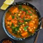 Mediterranean Soup in a rustic bowl with chickpeas, spinach, and lemon