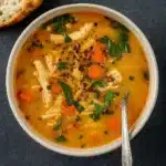 Simple Tuscan Soup in a rustic bowl with beans, spinach, and chicken