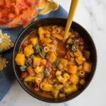 Butternut Squash Minestrone in rustic bowl with bread