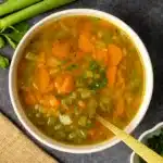 Carrot and celery soup in a rustic bowl on table
