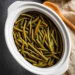 Crockpot Green Beans in white crockpot with lemon and garlic