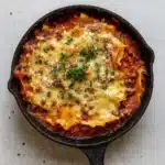 Easy One Pot Skillet Lasagna in cast iron skillet with fresh basil