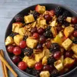 Fall fruit salad in glass bowl with cinnamon dressing