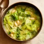 Garlicky Cabbage Soup in a rustic bowl with Parmesan