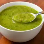 Green Detox Soup in a white bowl with fresh herbs