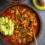 Ground Turkey Taco Soup in rustic bowl with toppings