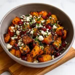 roasted butternut squash with cranberries and feta bliss served in bowl