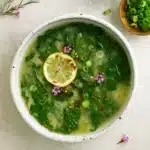 Roasted garlic miso soup with greens in a bowl