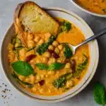 Bowl of Tuscan Chickpea Soup garnished with basil.
