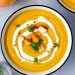 Velvety Apple Butternut Squash Soup Recipe served with cream swirl and thyme