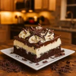 Brownie Refrigerator Cake slice with layers and chocolate garnish