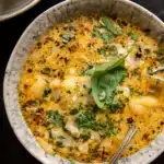 creamy chicken gnocchi soup in rustic bowl