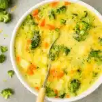 Creamy potato broccoli cheddar soup in a bowl on a rustic table