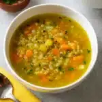 Healing Garlic Soup for Colds in a bowl with herbs