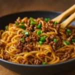 Mongolian Ground Beef Noodles in bowl with garnish