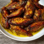 Baked turkey wings golden and crispy in baking dish