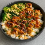 Delicious Sticky Chicken Rice Bowls served with sesame and green onions