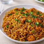 sticky garlic chicken noodles in a bowl with chopsticks