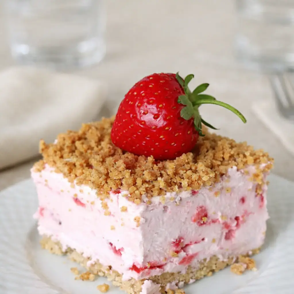 Easy Frozen Strawberry Dessert in a pan with strawberries