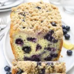 Lemon Blueberry Bread loaf sliced on cutting board