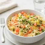 Lemon Capellini Salad in a rustic bowl with fresh lemons and olive oil