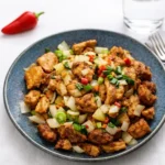Salt and Pepper Chicken on plate with chilies