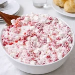 Strawberry Shortcake Fluff Salad in bowl with strawberries and cream