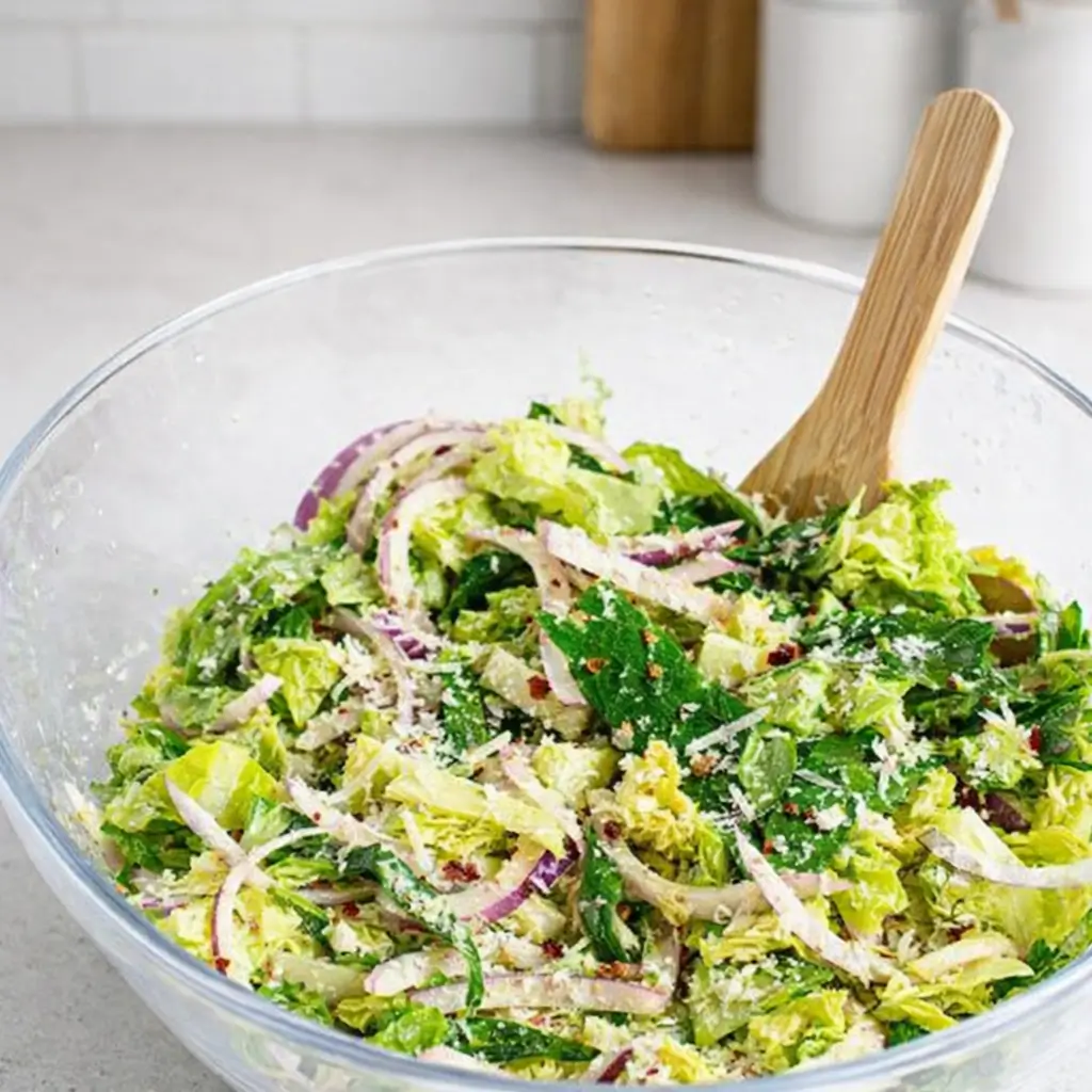 5-Minute Lemon Parmesan Lettuce Salad in a bowl with lemon and Parmesan.