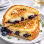 Crispy Blueberry Grilled Cheese sandwich with melted white cheddar and blueberry jam.
