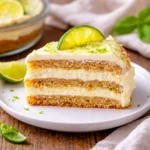 A delicious sliced Mexican Carlota de Limón with lime zest garnish.
